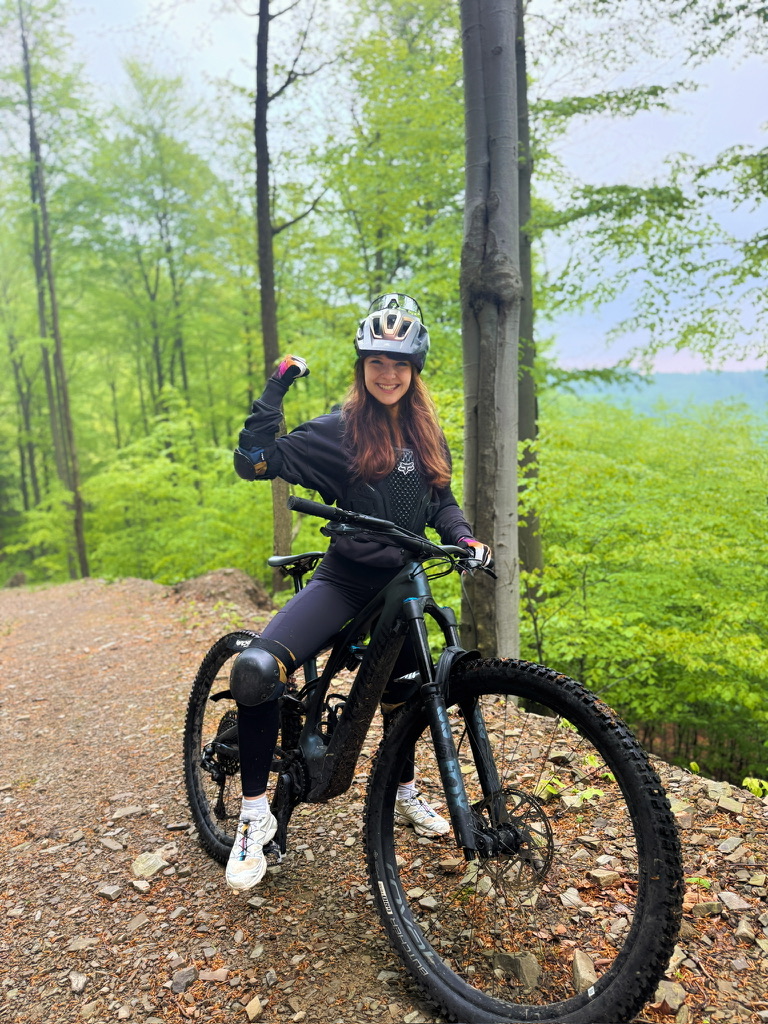 Marta on an MTB bike in the forest